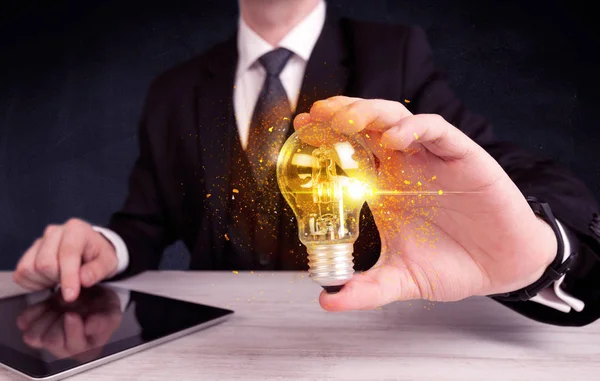 Office worker holding a light bulb — Stock Photo, Image