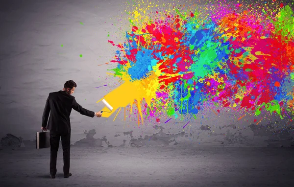 Sales person painting colorful splatter — Stock Photo, Image