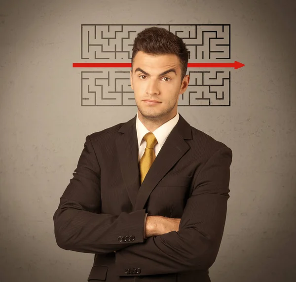 Handsome business guy solving maze — Stock Photo, Image