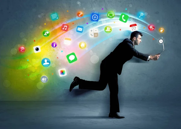 Running businessman with application icons from device — Stock Photo, Image