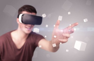 Adam sanal gerçeklik gözlüğü takıyor.