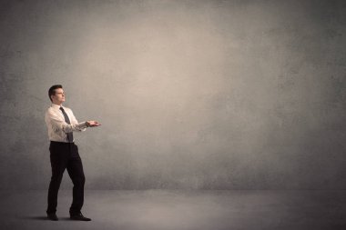 Boş bir duvarın önünde, ayakta işadamı