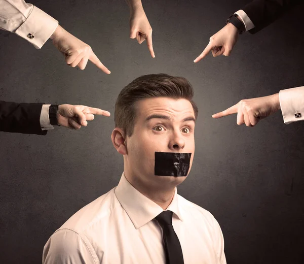 Multiple hands pointing at business employee — Stock Photo, Image