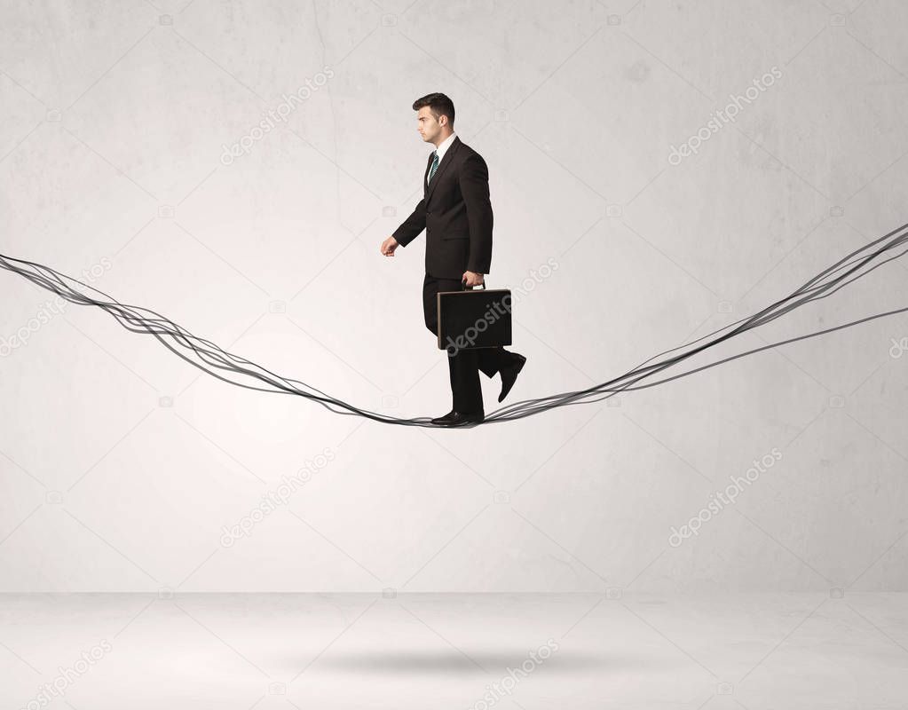 Sales person balancing on drawn ropes