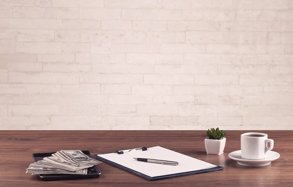 Office desk closeup with white brick wall