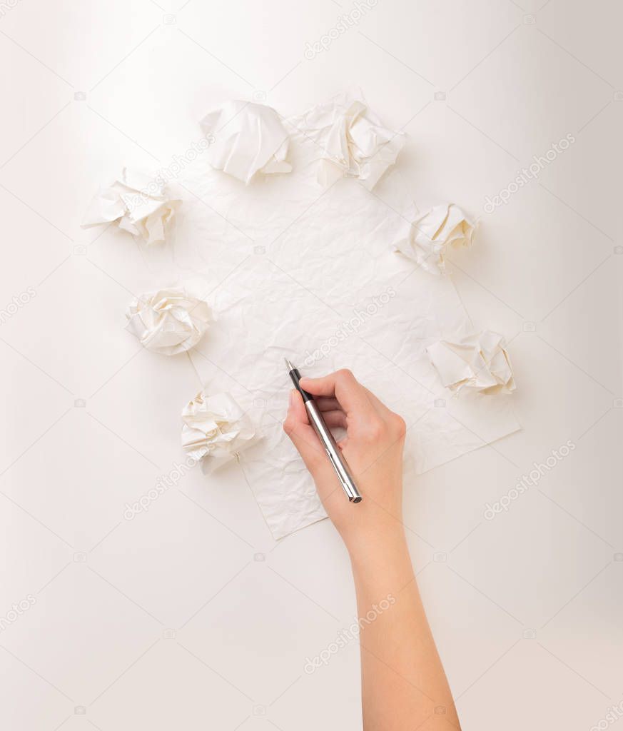 Writing hand in crumpled paper