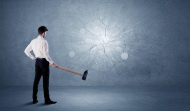 İşadamı çekiçle duvara çarpıyor.