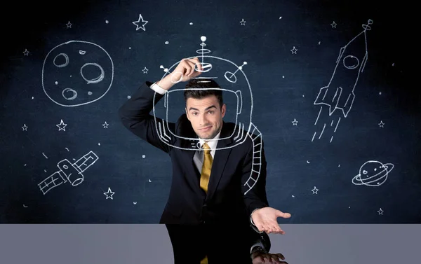 Sales person drawing helmet and space rocket