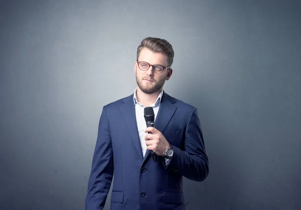 Businessman holding microphone — Stock Photo, Image