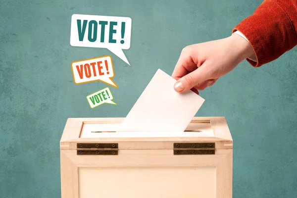 Placing a voting slip into a ballot box — Stock Photo, Image