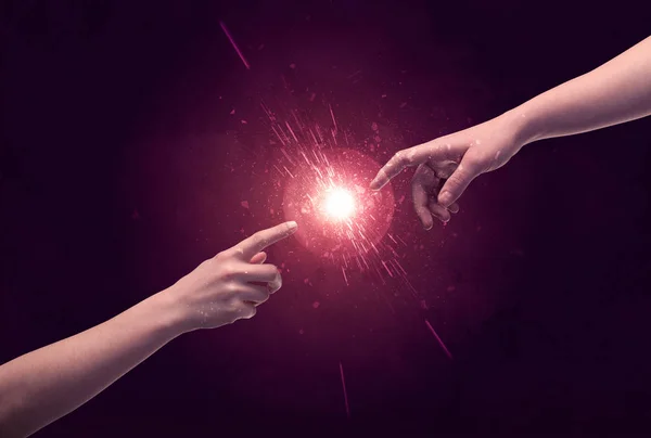 Touching hands light up sparkle in space