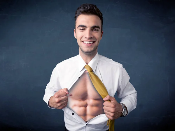 Businessman tearing off shirt and showing mucular body