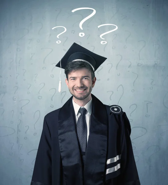 Young graduate teenager with question marks drawn — Stock Photo, Image