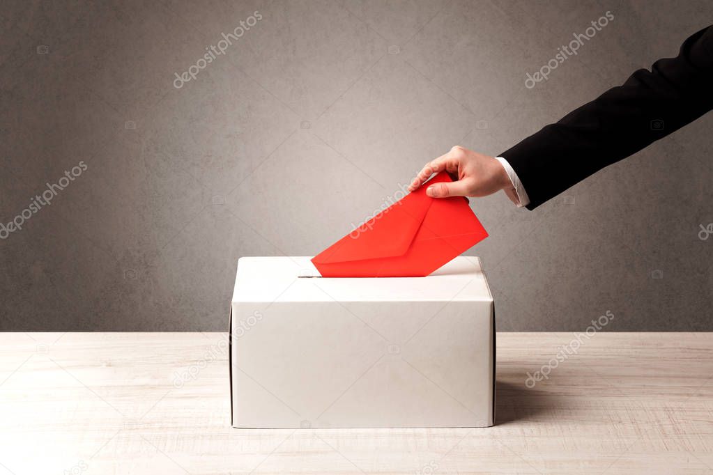 Ballot box with person casting vote 