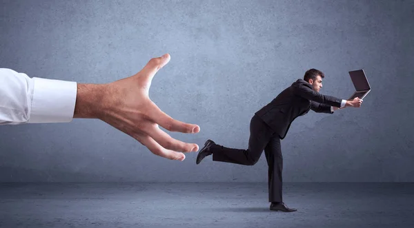 Businessman running from hand — Stock Photo, Image