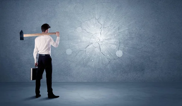 Business man hitting wall with a hammer — Stock Photo, Image