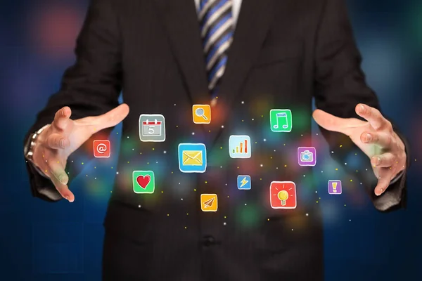 Businessman holding application icons — Stock Photo, Image