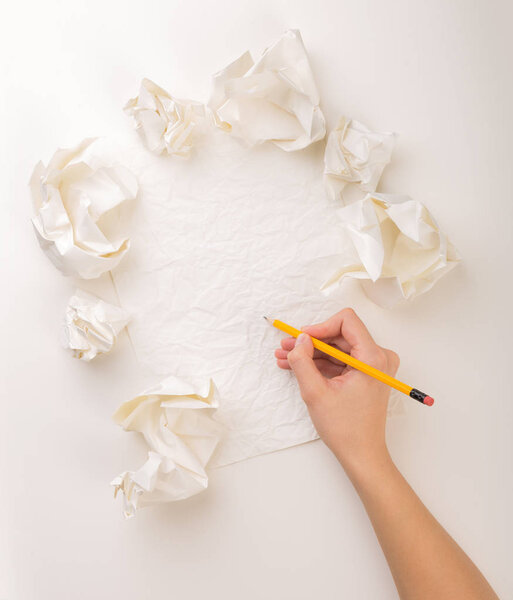 Writing hand in crumpled paper