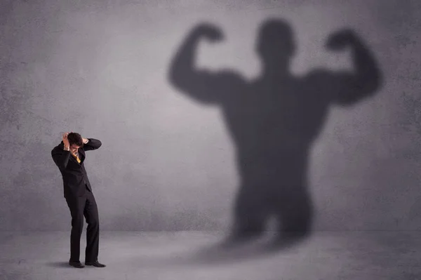 Business man looking at his own strong fit shadow concept — Stock Photo, Image