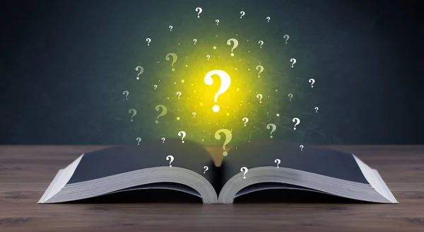 Question marks over book — Stock Photo, Image