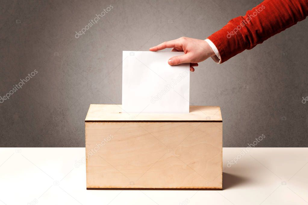 Ballot box with person casting vote 