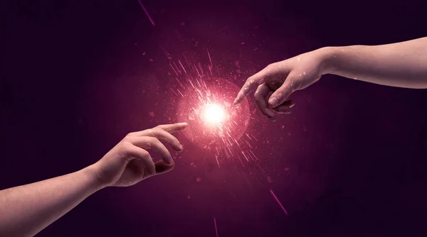 Touching hands light up sparkle in space