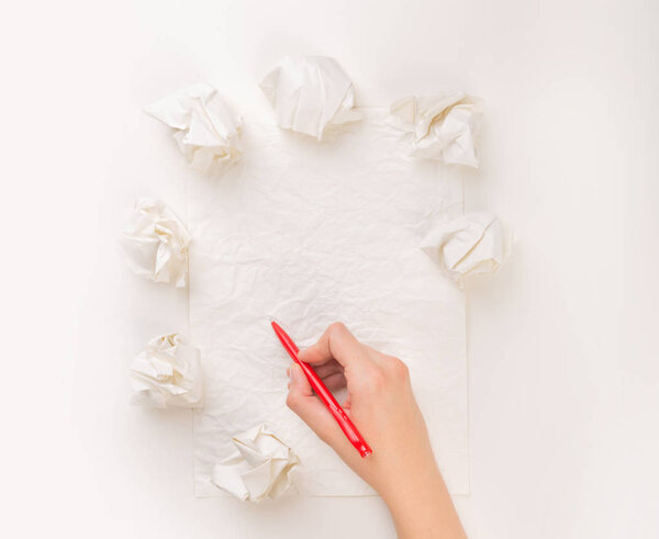 Writing hand in crumpled paper