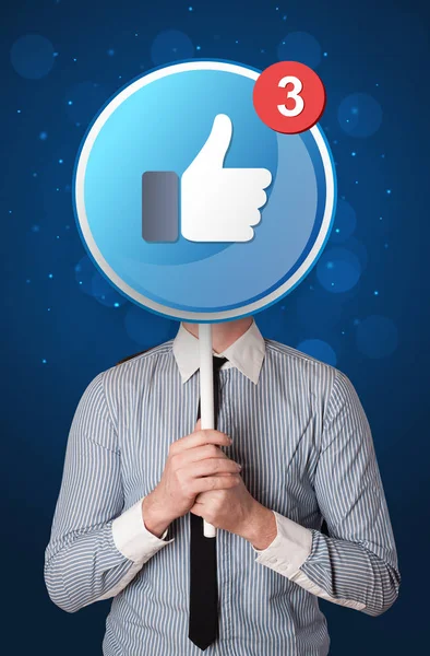 Businessman holding facebook sign — Stock Photo, Image