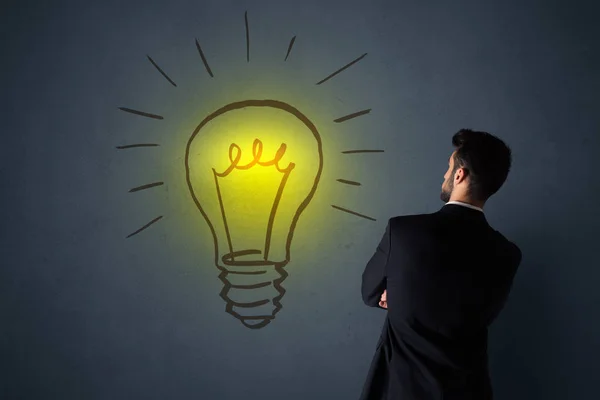 Businessman with lightbulb — Stock Photo, Image