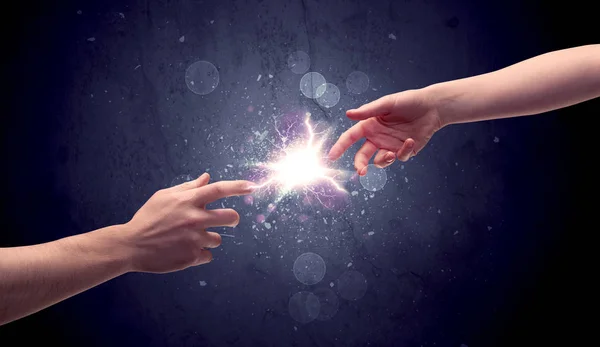 Hands reaching to light a spark — Stock Photo, Image