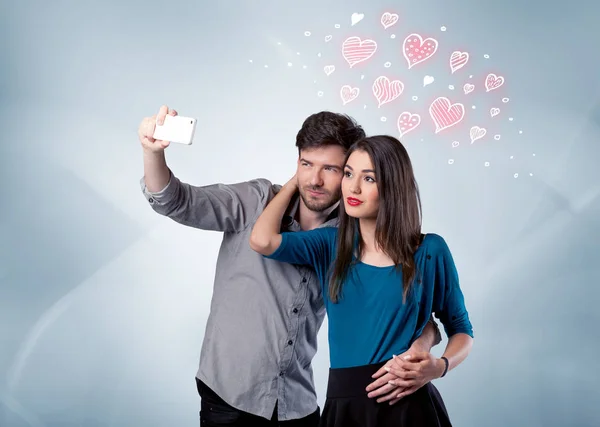 Couple in love taking selfie with red heart — Stock Photo, Image