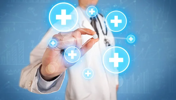 A doctor showing a pill with crosses — Stock Photo, Image