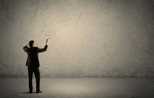 Verkoper met roller aan lege muur — Stockfoto