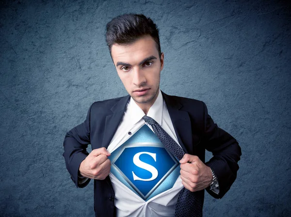 Businessman ripping off his shirt with superhero sign — Stock Photo, Image