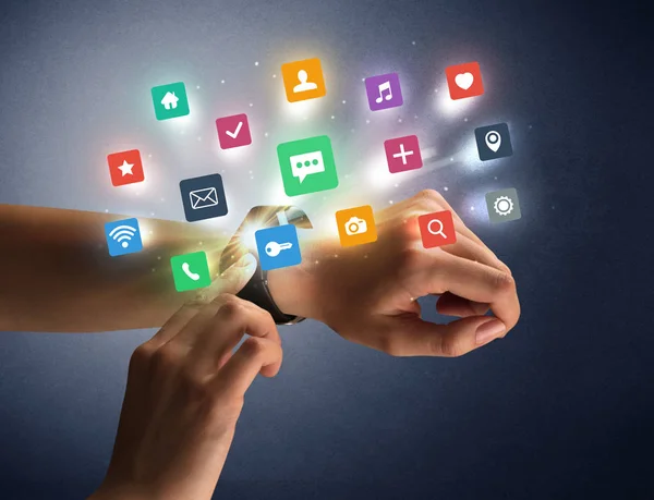 Female hand wearing smartwatch with app icons — Stock Photo, Image