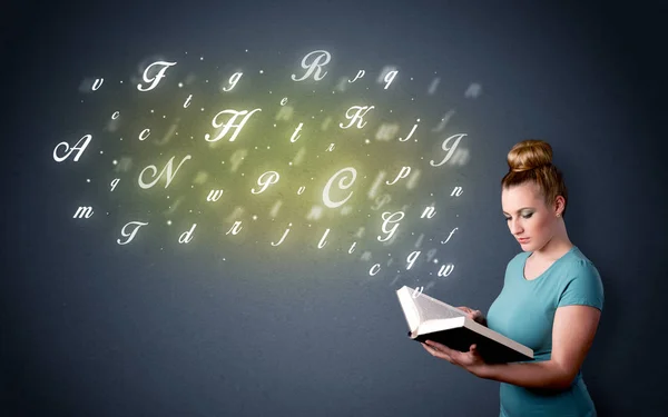 Young lady holding book with letters — Stock Photo, Image