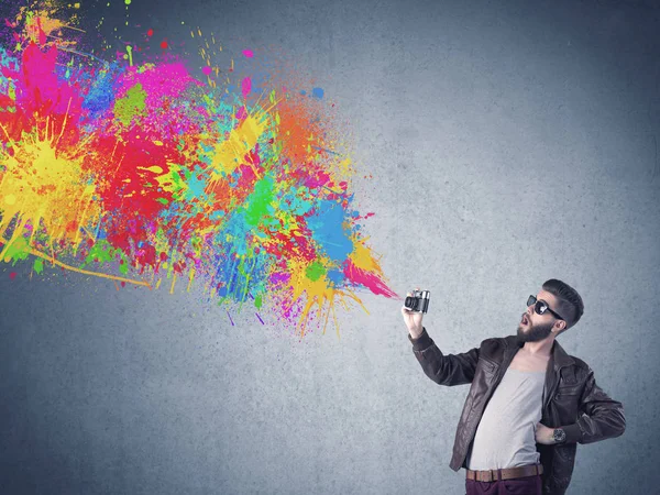 Hipster guy with camera and paint splash — Stock Photo, Image