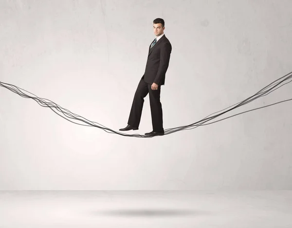 Sales person balancing on drawn ropes