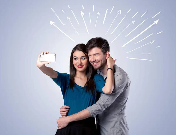 Cute couple taking selfie with arrows — Stock Photo, Image