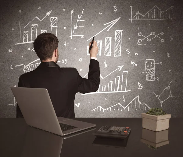 Businessman drawing sales charts on wall — Stock Photo, Image