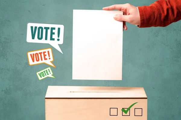 Placing a voting slip into a ballot box — Stock Photo, Image