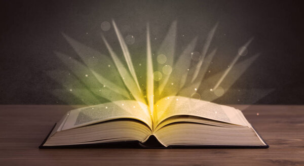 Yellow lights spreading from an open book