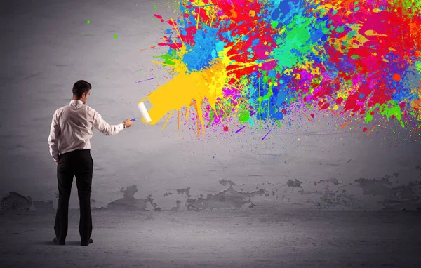 Sales person painting colorful splatter — Stock Photo, Image