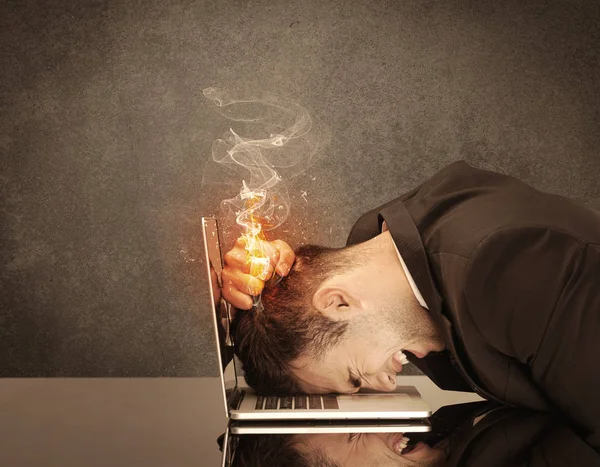 Sad business person's head catching fire