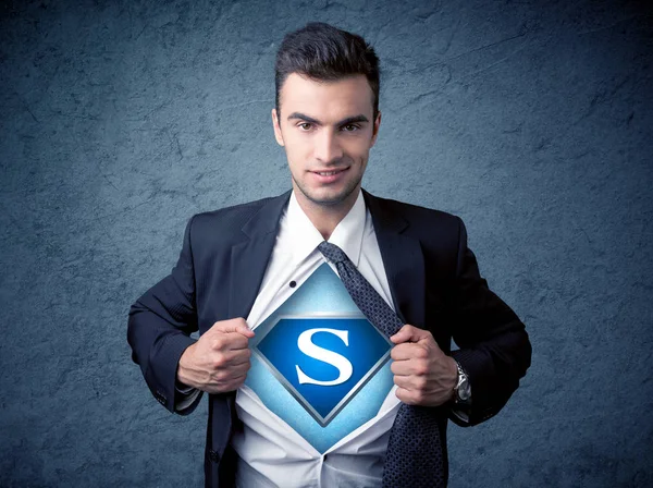 Businessman ripping off his shirt with superhero sign — Stock Photo, Image