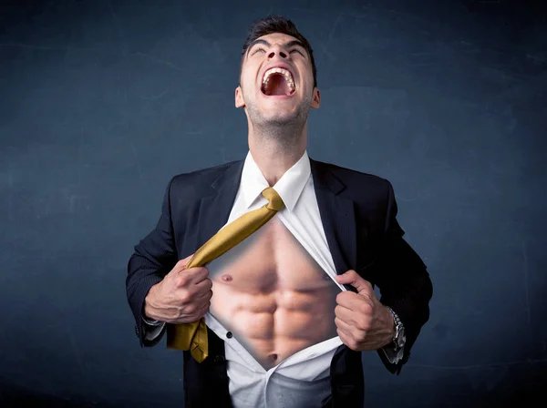 Businessman tearing off shirt and showing mucular body — Stock Photo, Image
