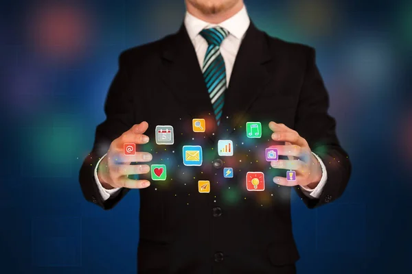 Businessman holding application icons — Stock Photo, Image