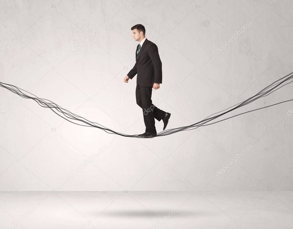 Sales person balancing on drawn ropes