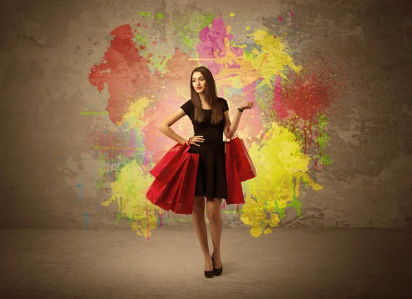 Girl with shopping bags and paint splatter — Stock Photo, Image