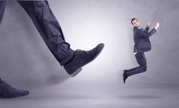 Foot kicking, businessman flying — Stock Photo, Image